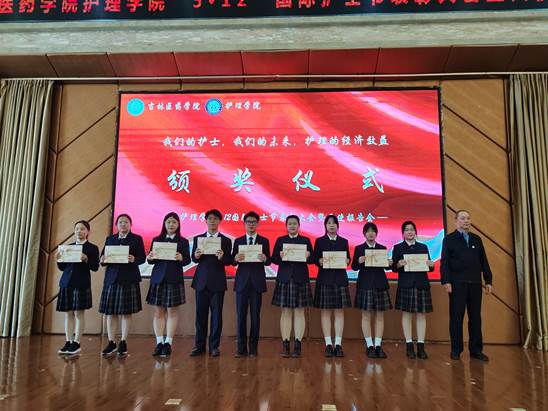 学校纪委书记吕海龙(右一)为优秀学生干部代表颁奖